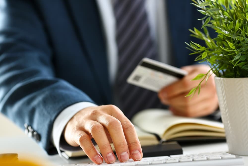 Les bras tiennent les boutons de la carte de crédit